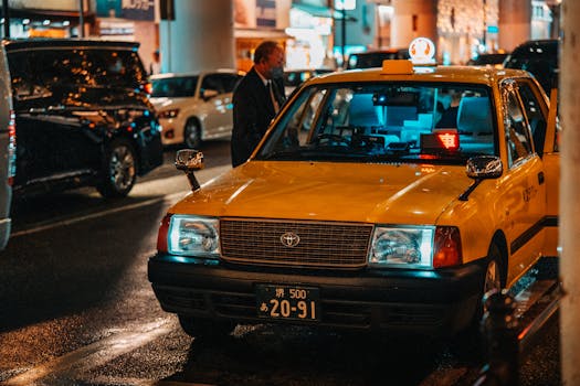 A vibrant night scene of a yellow taxi in Dotonbori, Osaka, capturing the city's lively atmosphere.