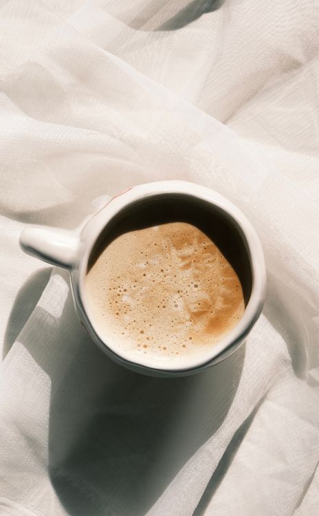 Aerial View of Coffee Cup on White Fabric  Free Stock Photo