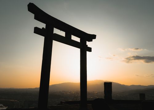 Free A stunning silhouette of a Torii gate against a colorful sunset sky in Ikeda, Japan. Stock Photo