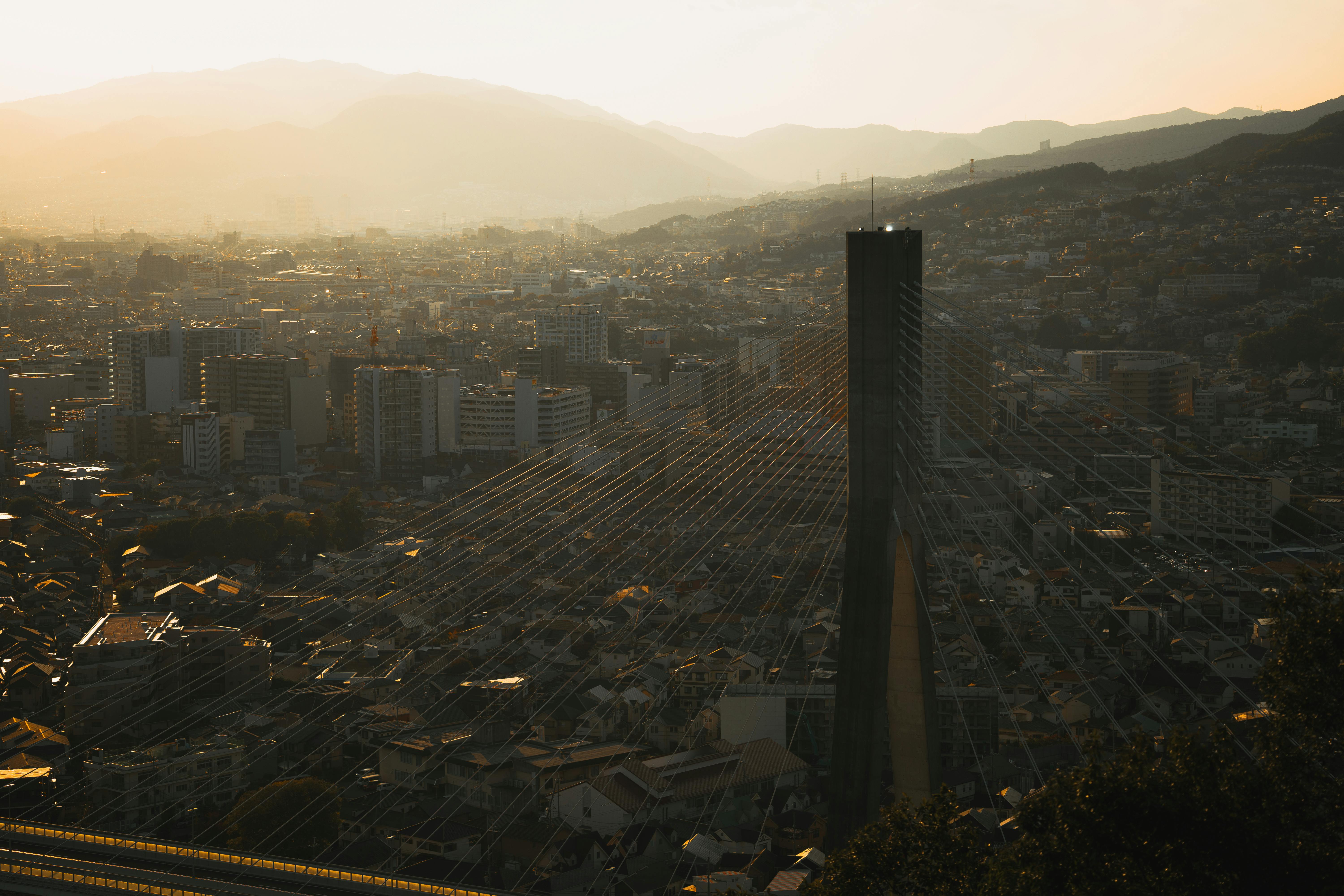 A stunning view of Ikeda cityscape during sunset featuring a prominent cable-stayed bridge.