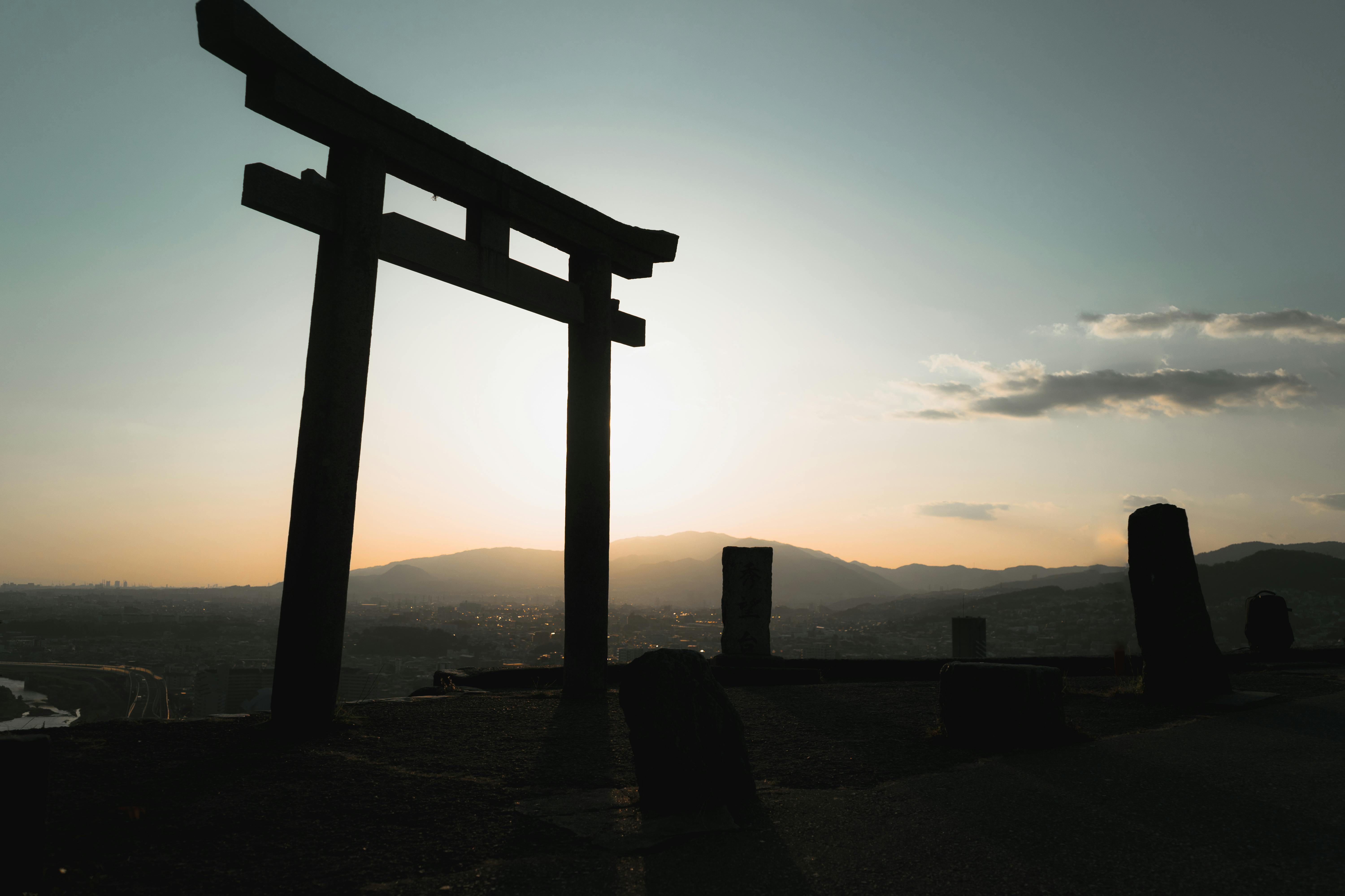 Silhouette of a Torii gate with a sunset backdrop in Ikeda, Osaka, Japan.