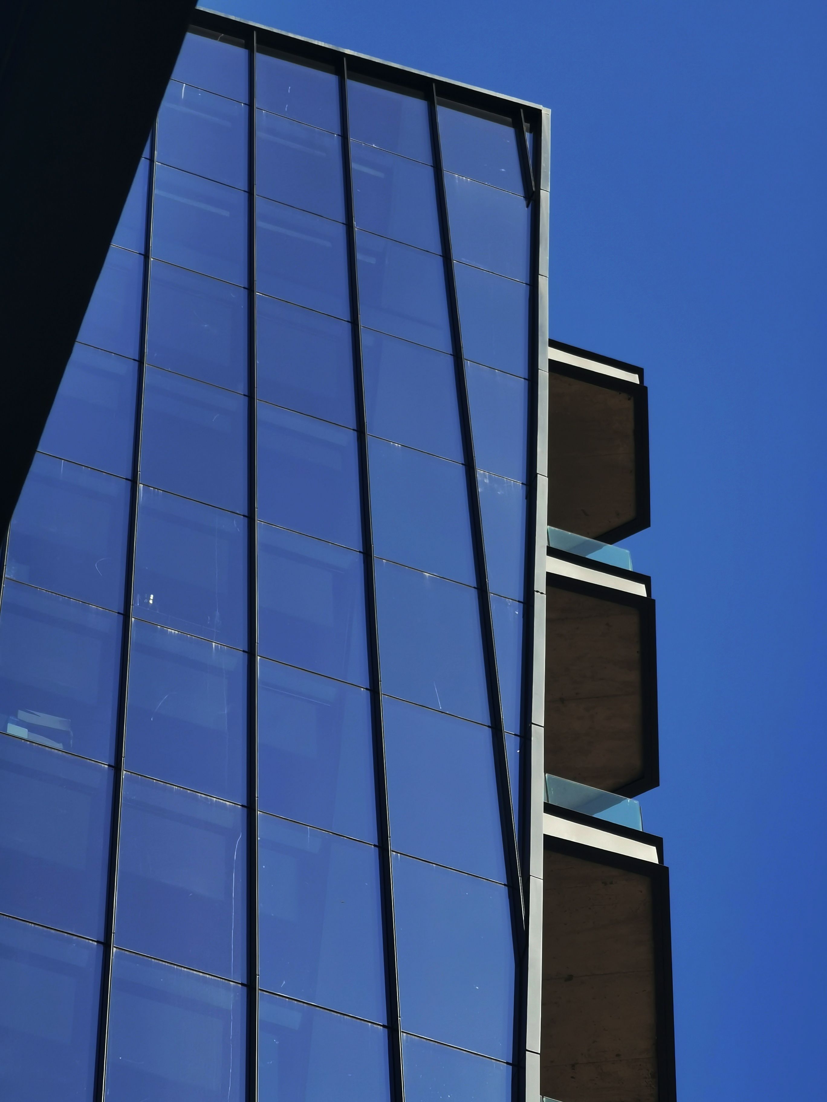 Modern Glass Skyscraper Against Clear Blue Sky · Free Stock Photo