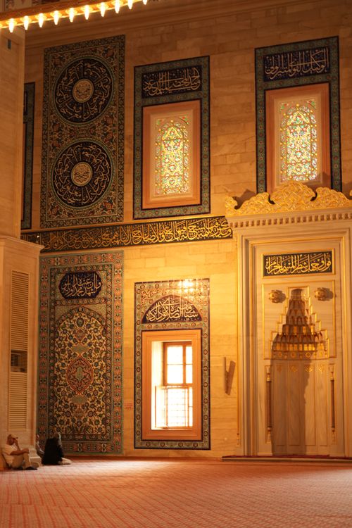 Free Elegant mosque interior with intricate wall art and Arabic calligraphy. Stock Photo