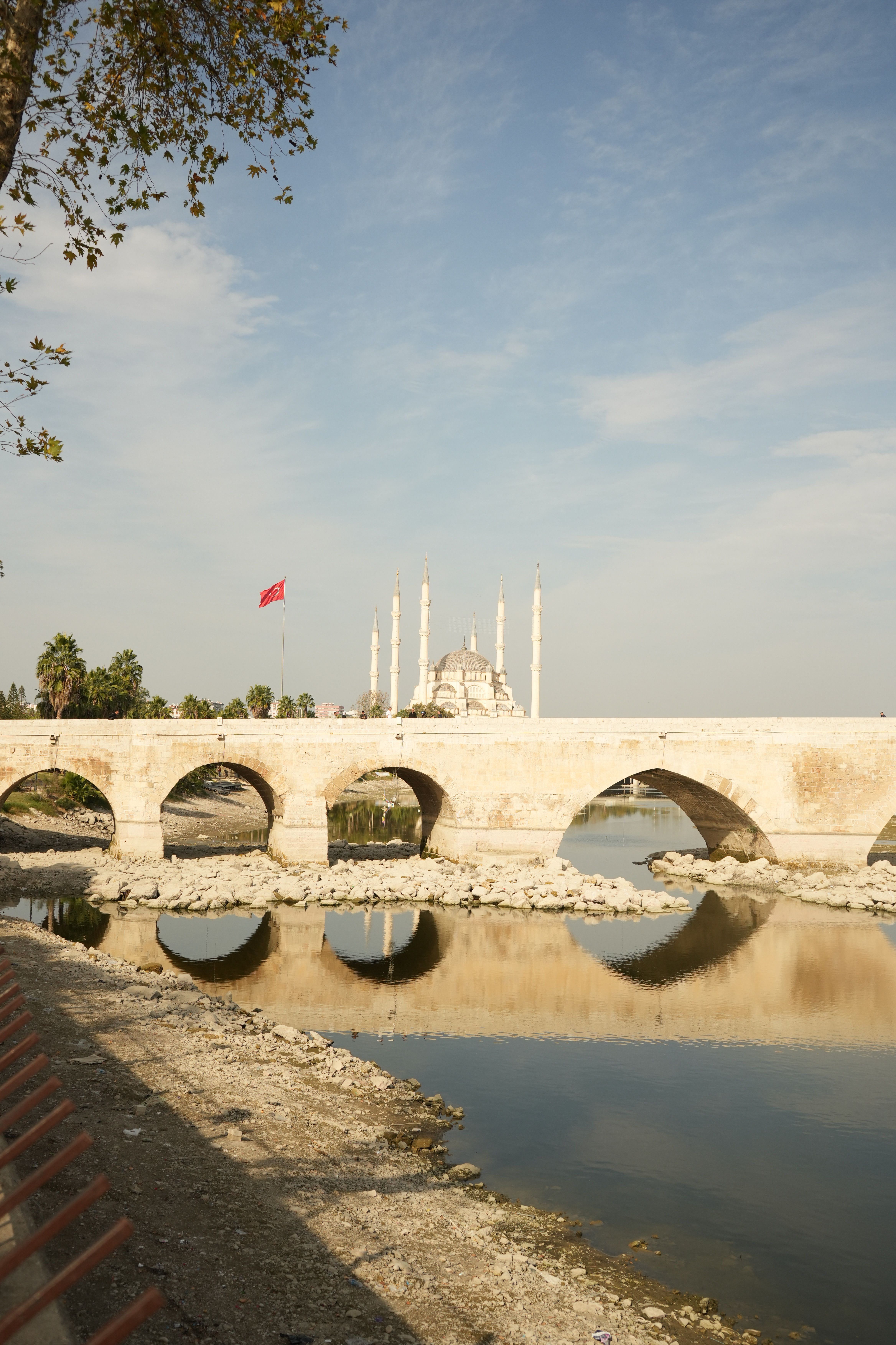 Historic Stone Bridge and Mosque Reflection at Sunset · Free Stock Photo