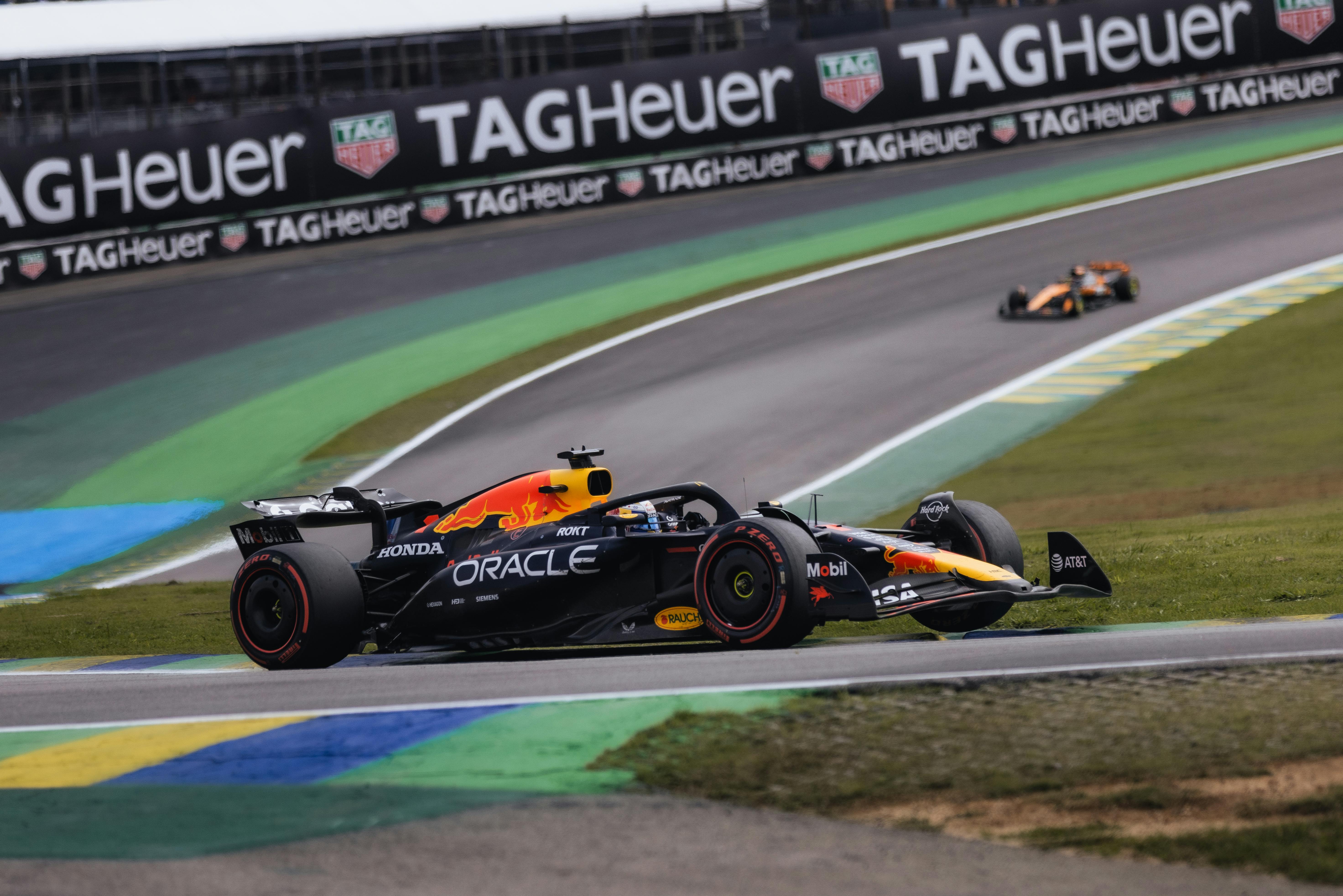 Action-packed moment during a Formula 1 race at the Interlagos Circuit, showcasing Red Bull car.