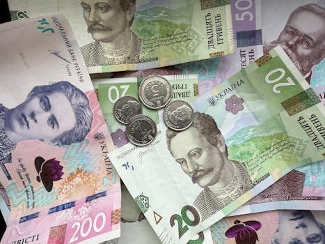 Detailed image of Ukrainian hryvnia banknotes and coins displaying design and denomination.