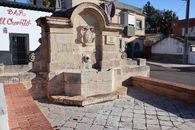 Stone fountain in Andalusian town, showcasing heritage architecture.