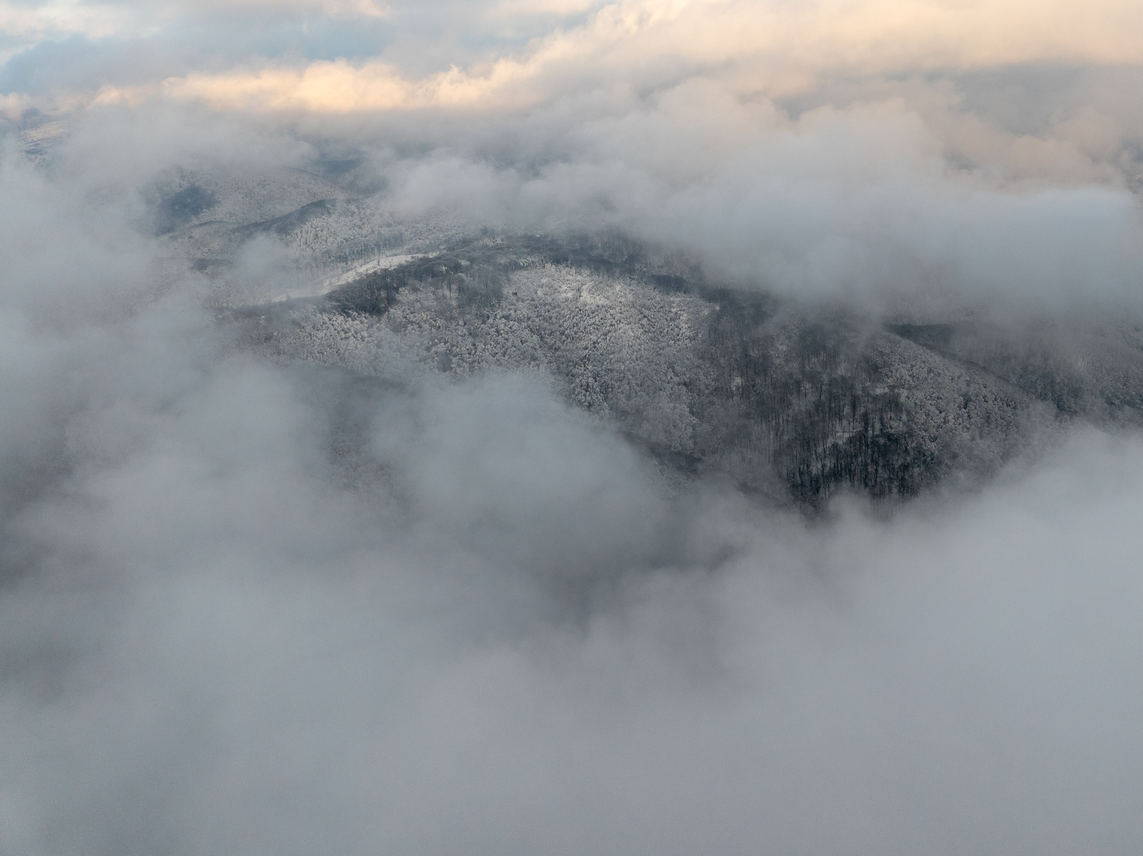 Aerial View of Snow-Covered Mountains in Clouds · Free Stock Photo