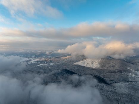 Breathtaking aerial photograph of snow-covered mountains and clouds in Daruvar, Croatia during winter.