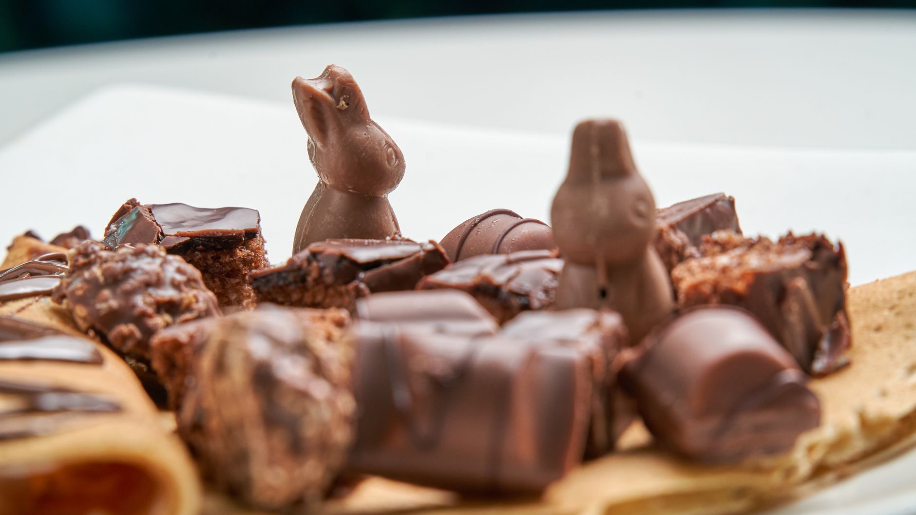 Close-up of assorted chocolate treats including rabbit-shaped chocolates on a dessert plate.