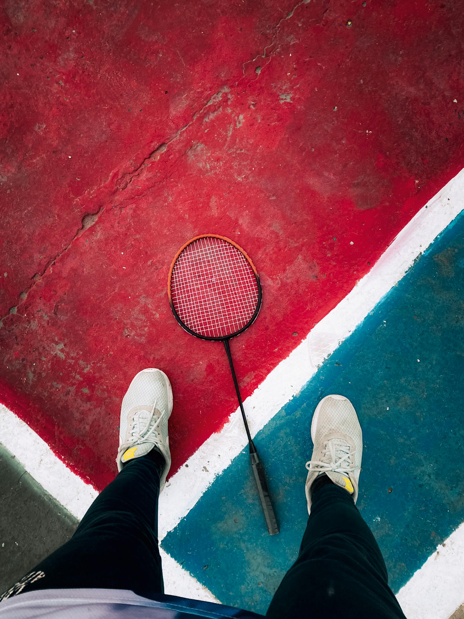 Overhead view of badminton courts with players in action