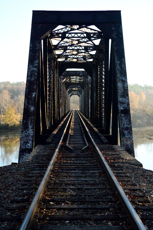 Free Rustic railway bridge crossing over Catawba River in North Carolina during sunrise. Stock Photo