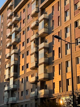 A modern apartment building facade beautifully lit by sunset light.