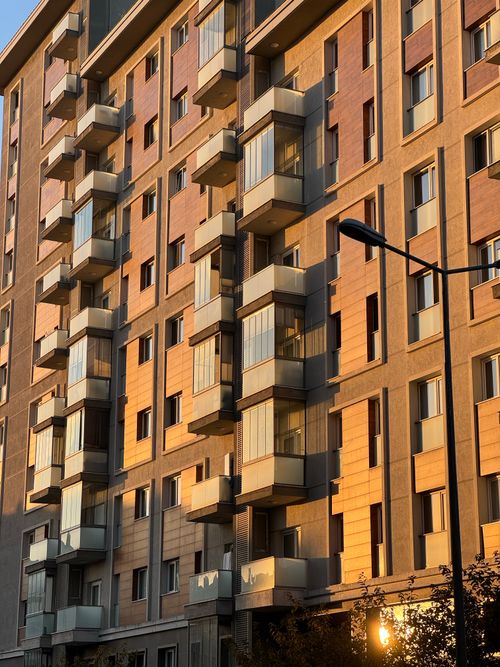 Free A modern apartment building facade beautifully lit by sunset light. Stock Photo