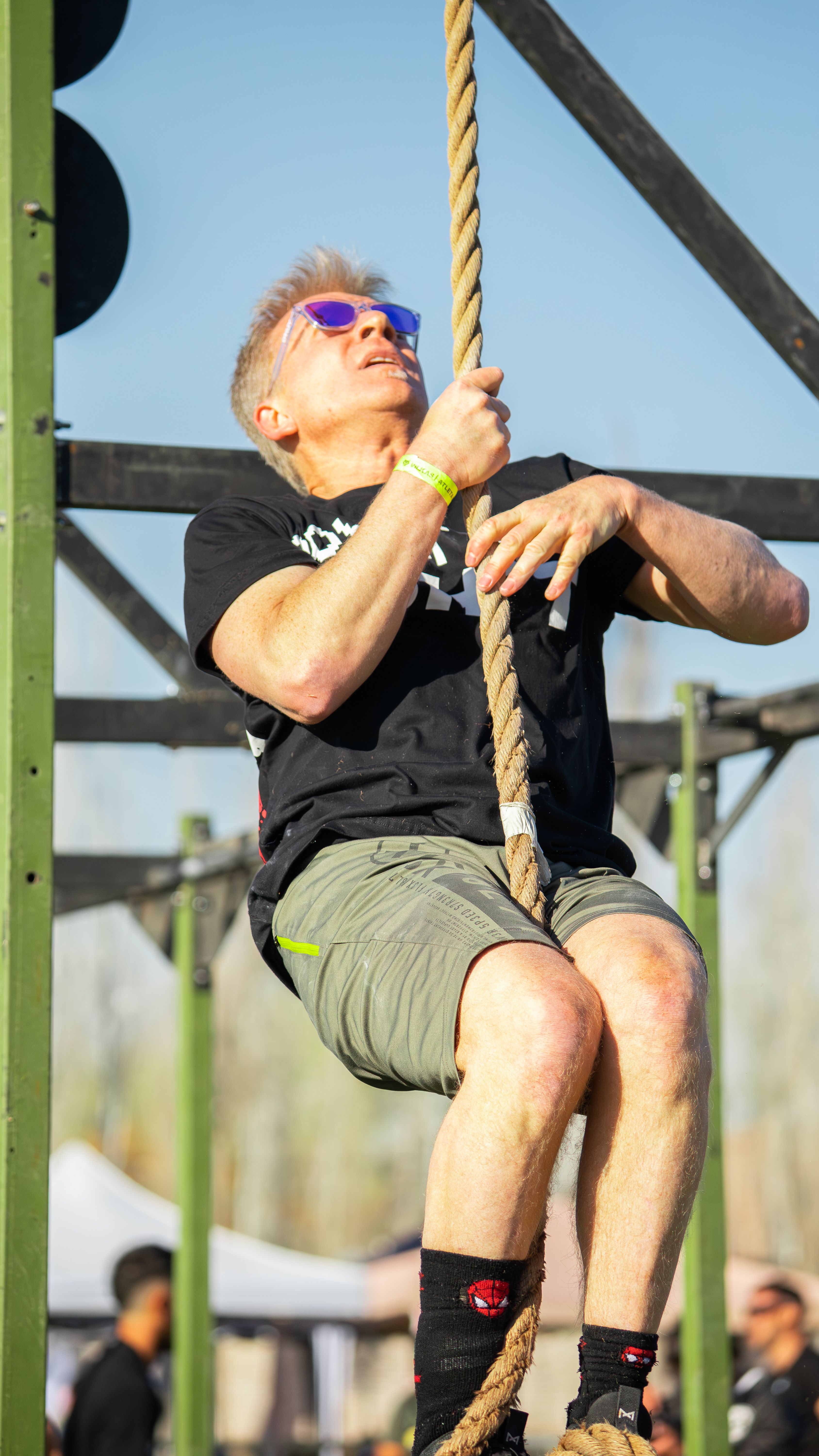 Athlete Climbing Rope in Outdoor Competition · Free Stock Photo