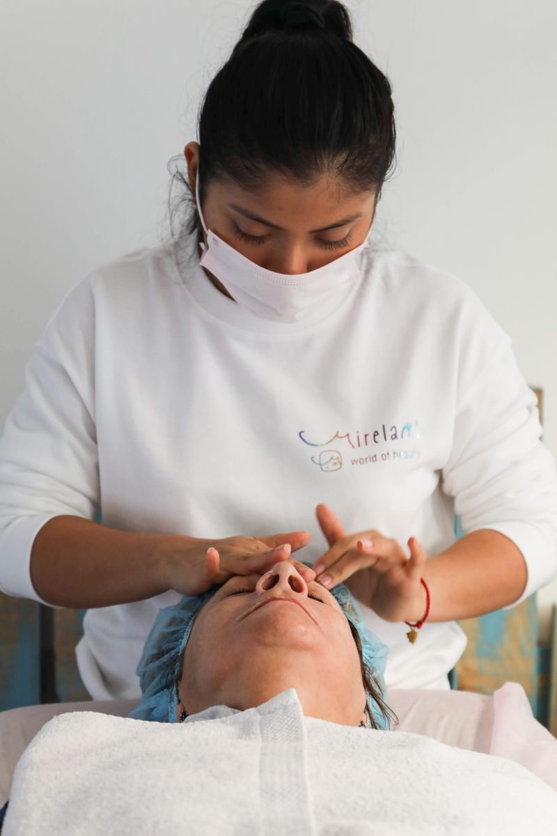 A therapist performing a facial massage