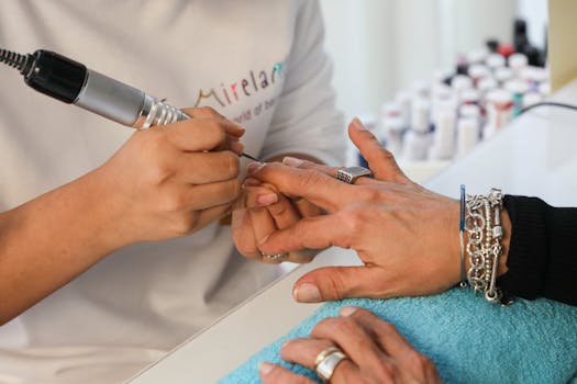Close-up of a professional nail manicure at a beauty salon, showcasing intricate detail.