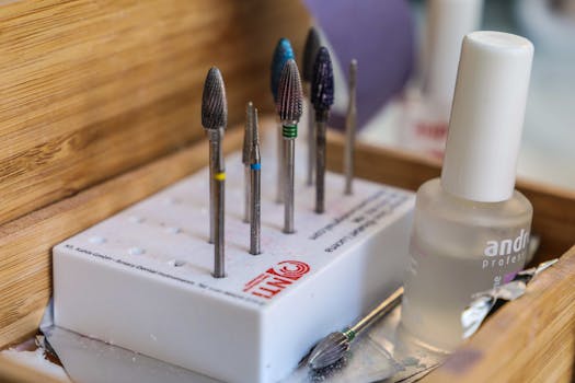 Detailed view of manicure drill bits and polish for nail care.