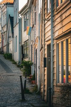 Peaceful cobblestone street in Bergen, Norway featuring traditional wooden houses.