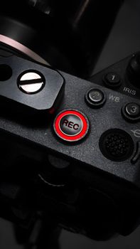 Close-up of a camera REC button highlighting its design and functionality in low light conditions