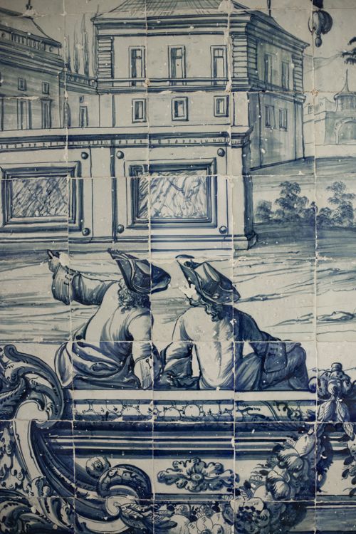 Free Vintage blue and white azulejo tiles depicting classic Lisbon architecture and figures. Stock Photo