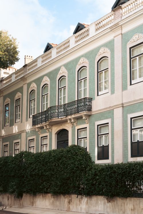 Free Elegant facade of a historical building in Lisbon with ornate details and green tiles. Stock Photo