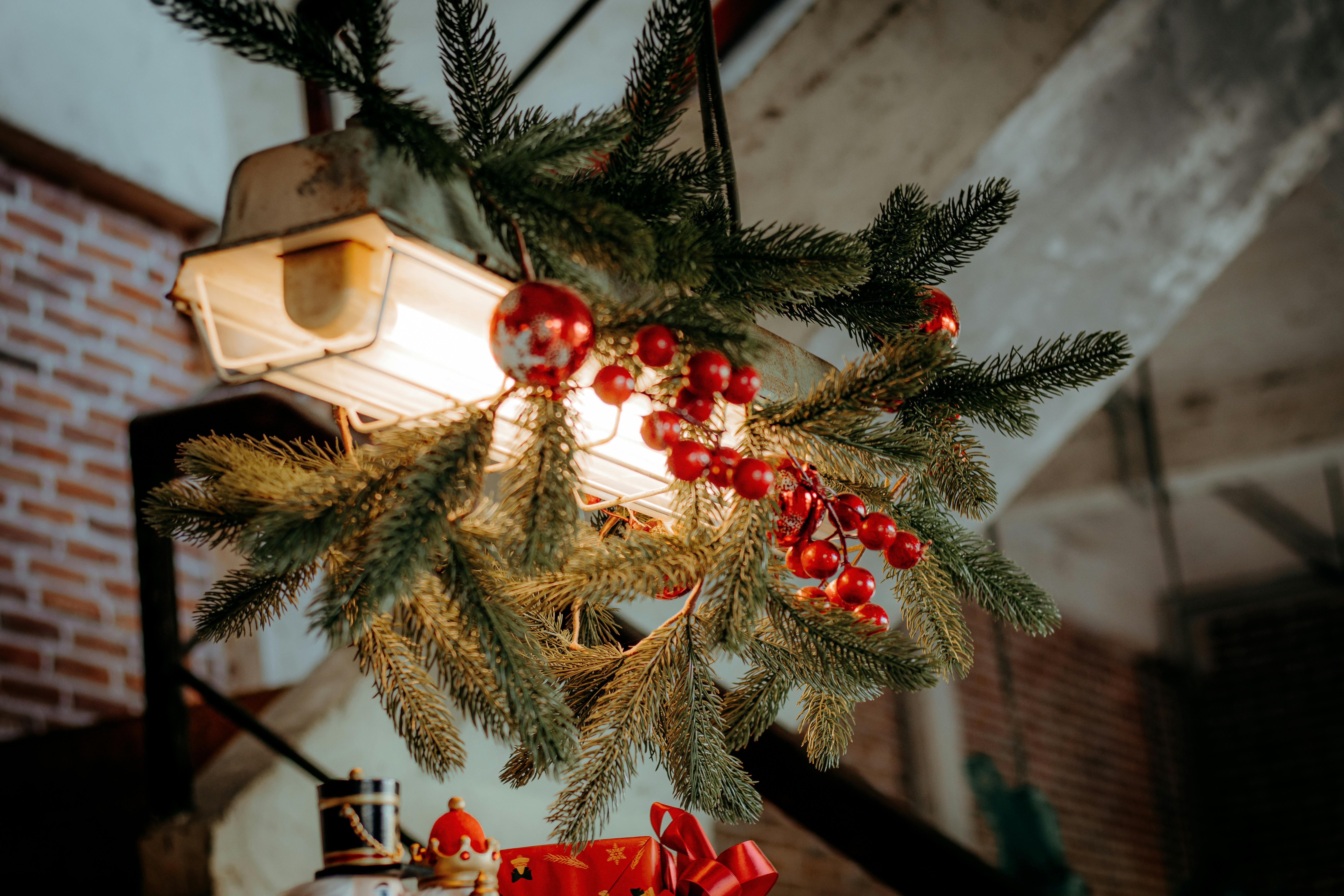 Close-up of Christmas greenery and ornaments under warm indoor lighting.