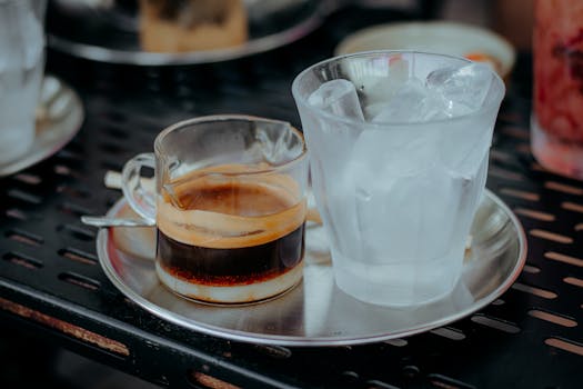 Close-up view of coffee and ice on a cafe table, inviting refreshment.