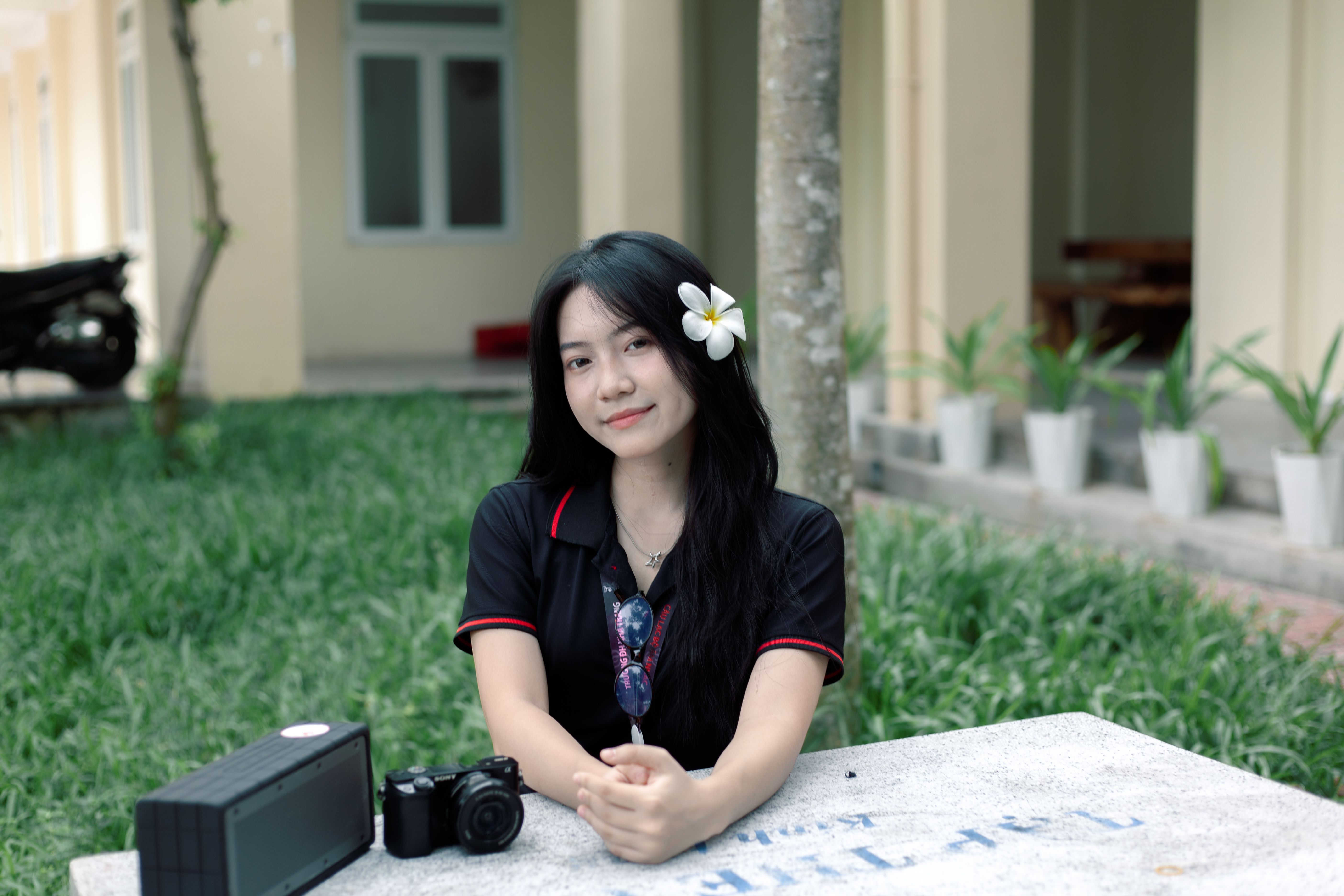 Young Woman Smiling Outdoors with Camera · Free Stock Photo