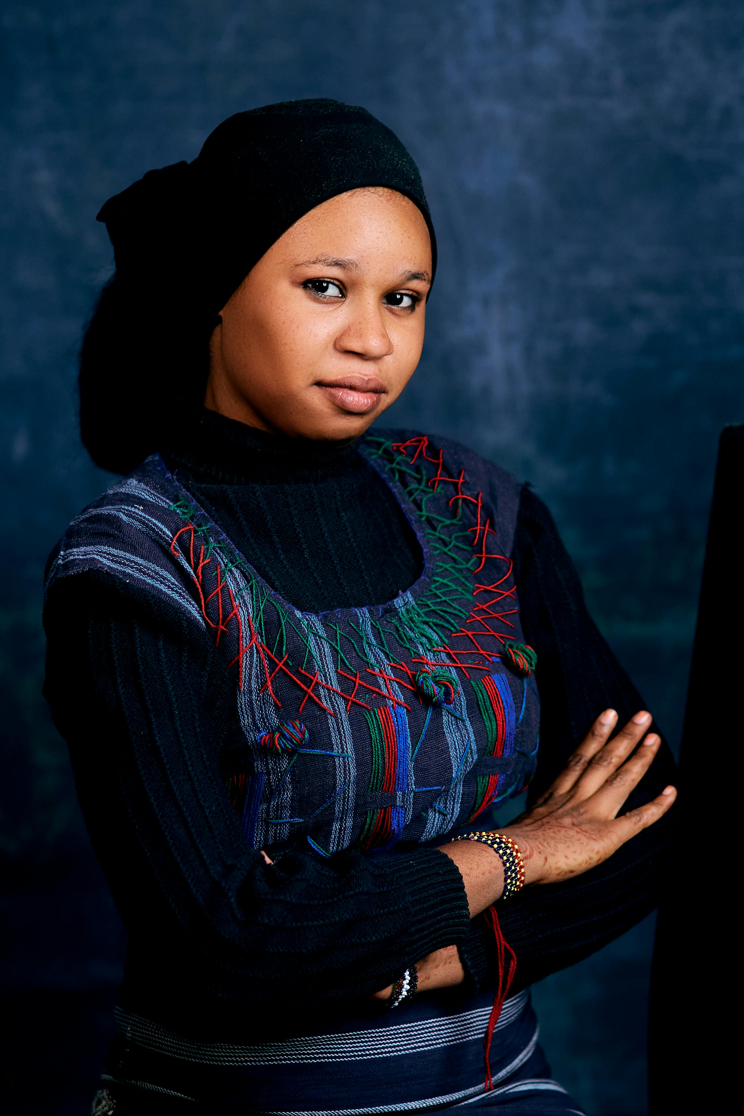 Portrait of a confident woman in traditional attire with a serene expression.