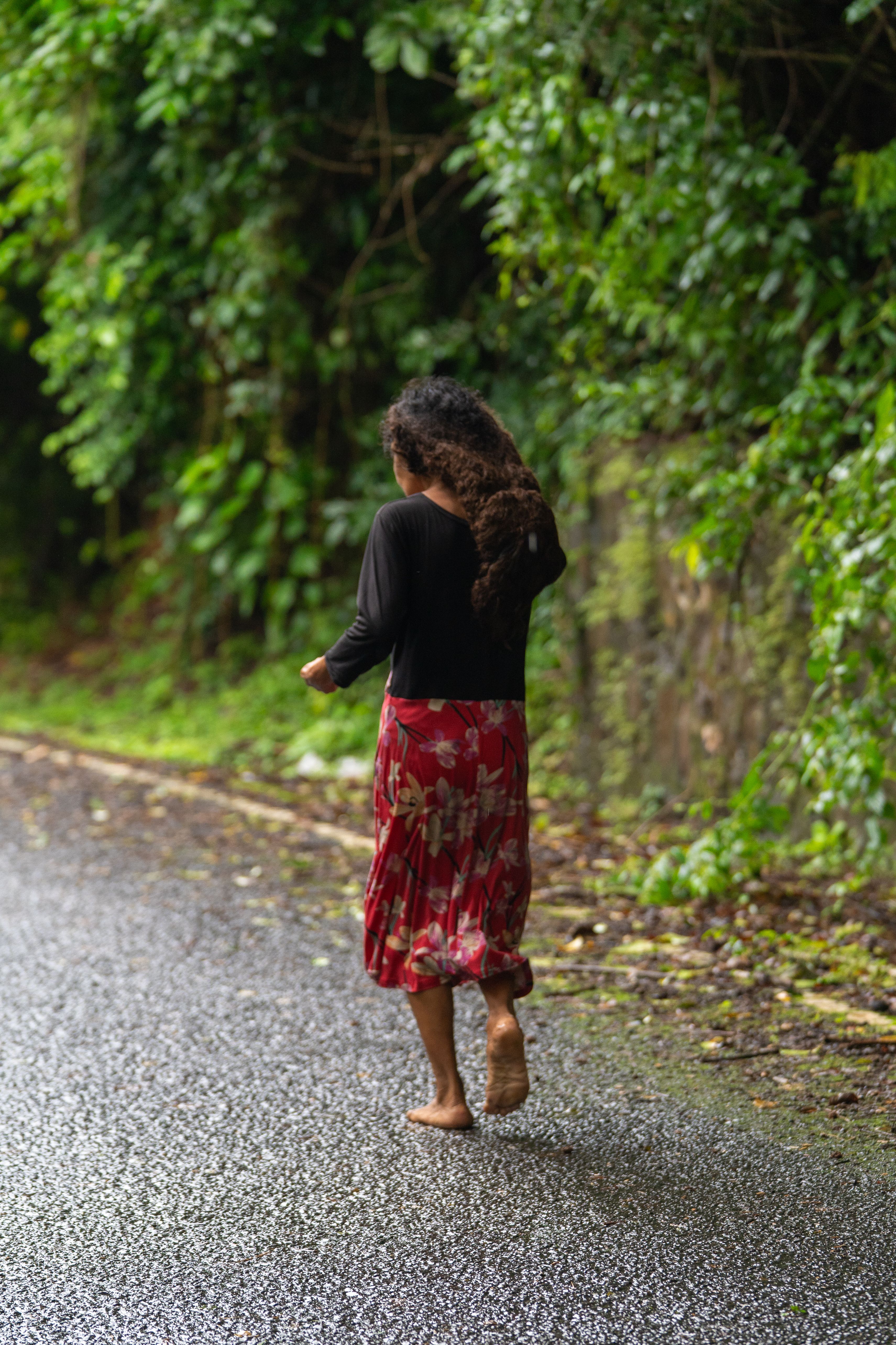 Woman Walking on a Rainy Forest Path · Free Stock Photo