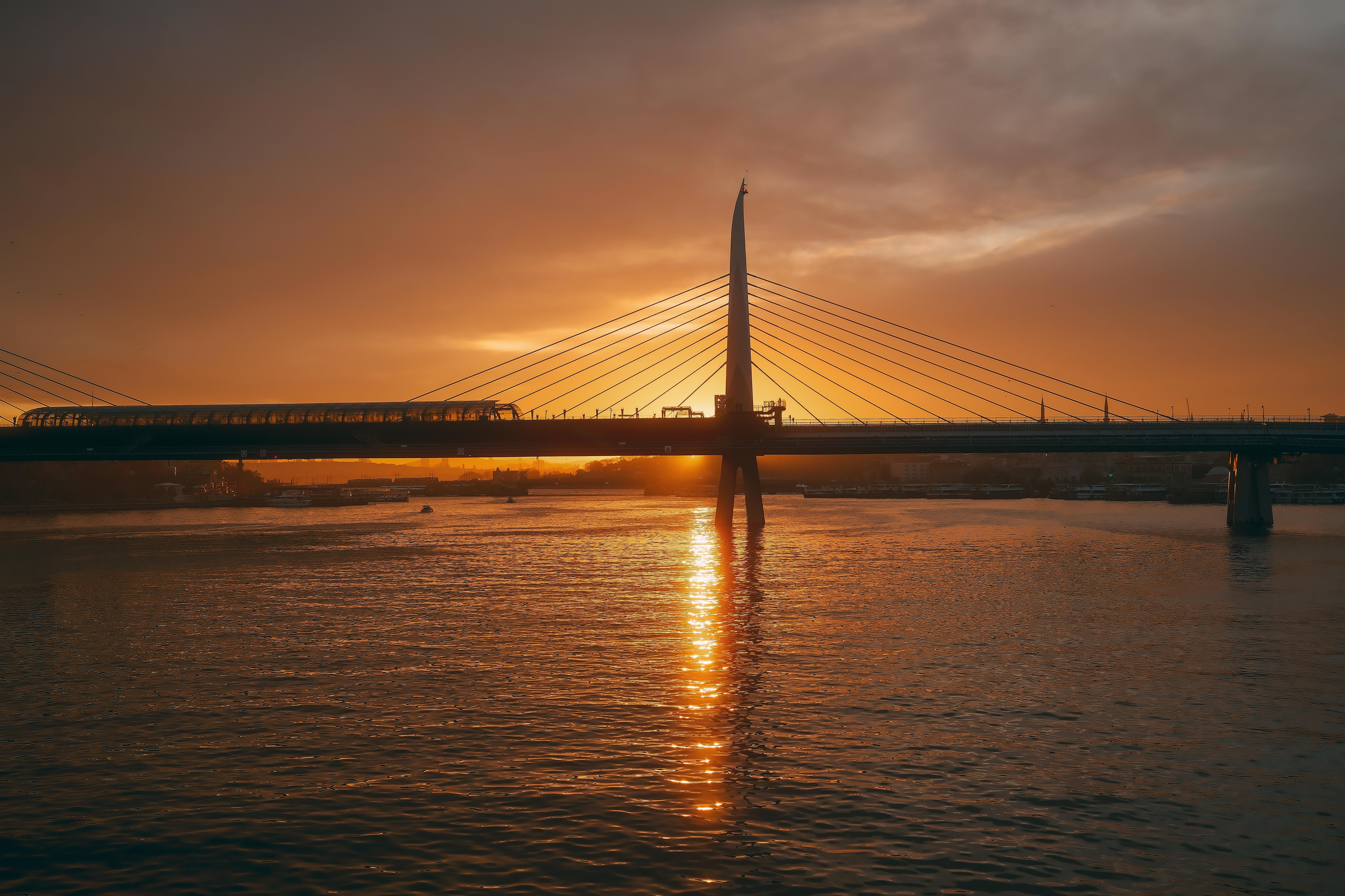 Sunset Reflecting Off Modern Suspension Bridge · Free Stock Photo