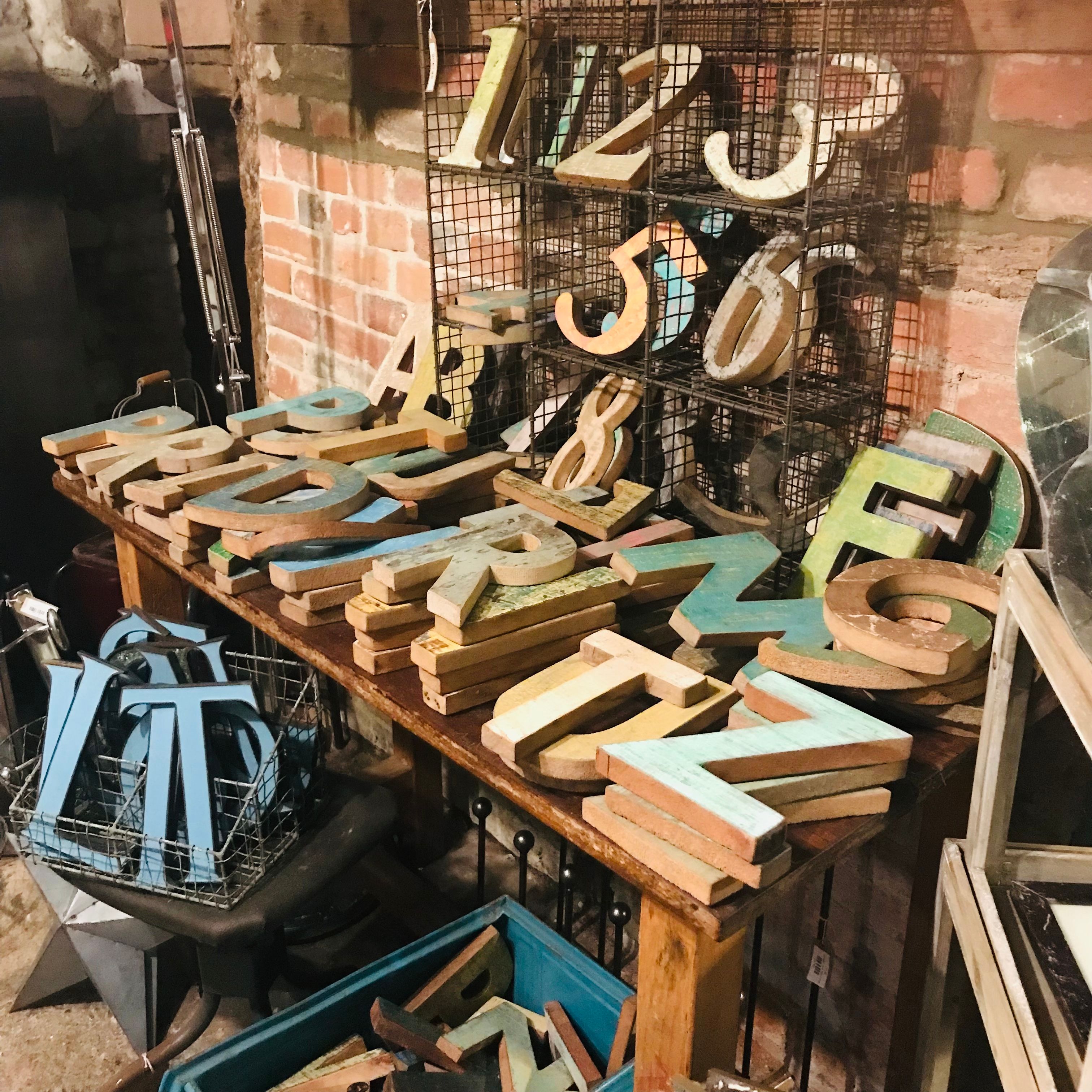 Assorted vintage wooden display letters on a workbench — Anne-marie _ on Pexels
