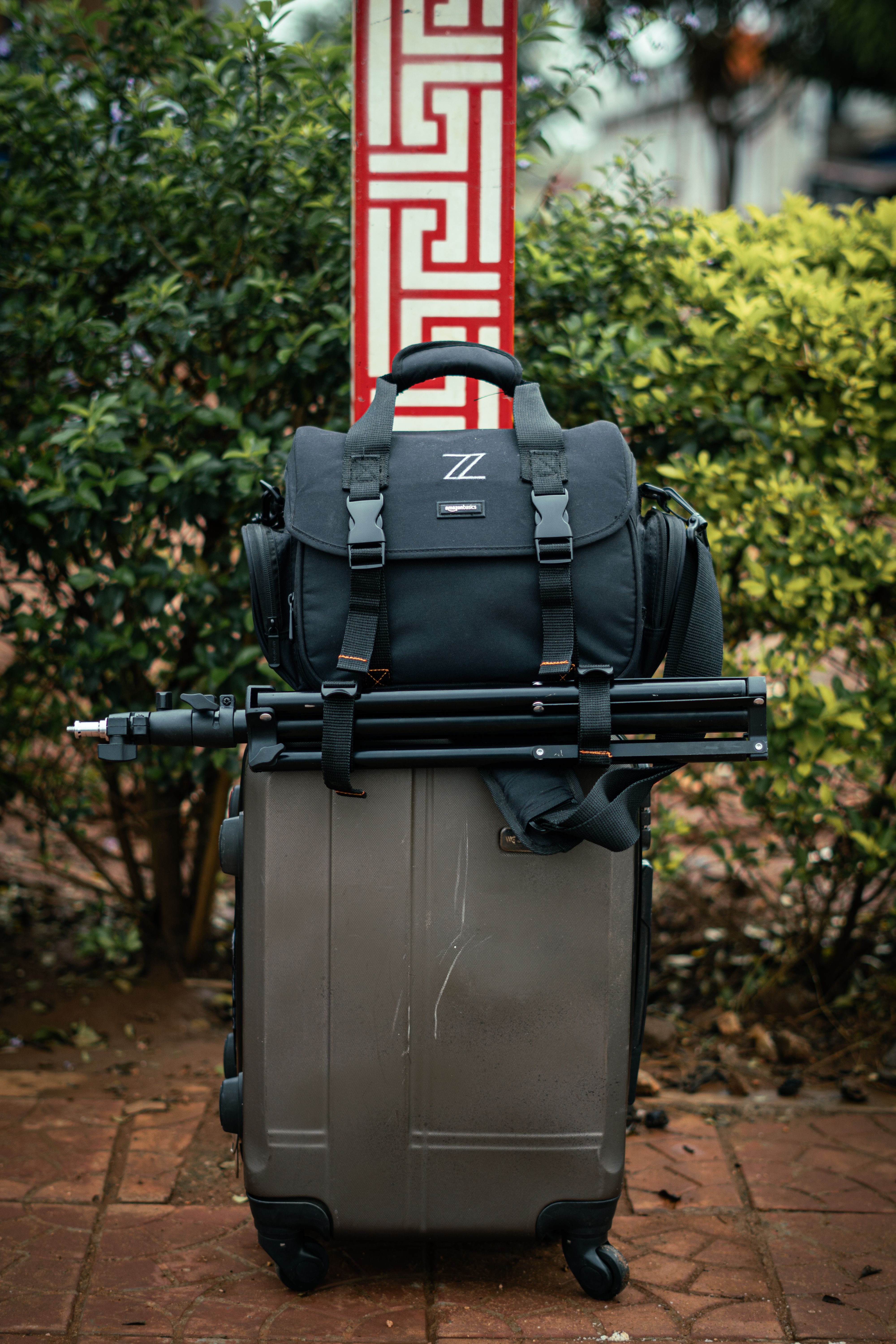 Suitcase, camera bag, and tripod setup outdoors in Lilongwe, Malawi.
