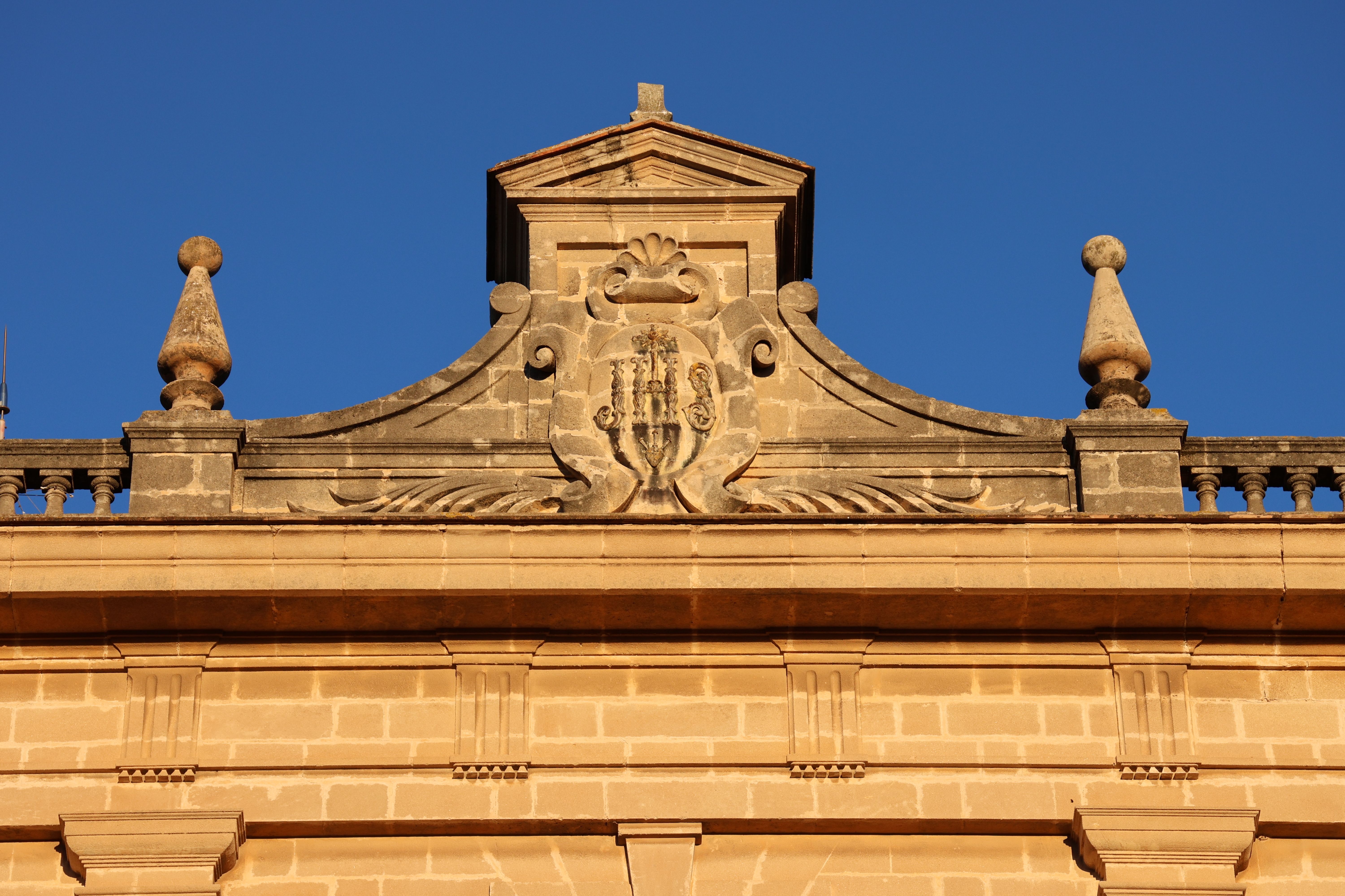 Historic Architectural Facade Under Clear Blue Sky · Free Stock Photo