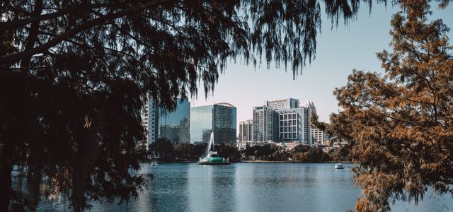 Captivating view of downtown Orlando skyline framed by trees at Lake Eola.