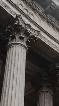 A close-up view of ornate Roman columns featuring Corinthian capitals, an iconic architectural style.