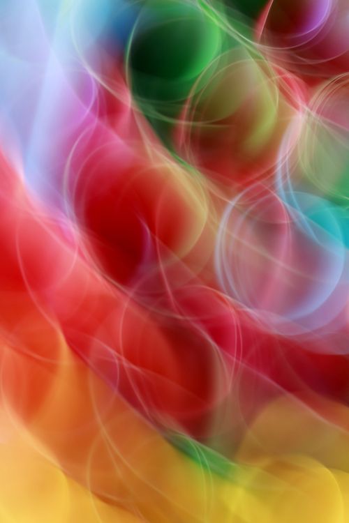 Free Vibrant abstract with colorful light bokeh circles on a blurred background. Stock Photo