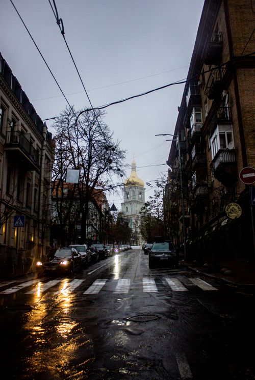Free A rainy street leads to the iconic St. Sophia Cathedral in Kyiv, under a cloudy sky. Stock Photo