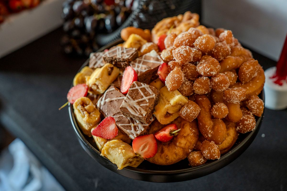 Vibrant assortment of delicious pastries and sweets with strawberries and chocolate, perfect for dessert lovers.