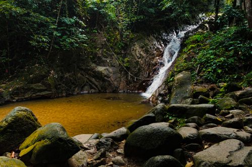 Free A serene waterfall cascading into a rocky pool in Labis Forest Reserve, Johor, Malaysia. Stock Photo