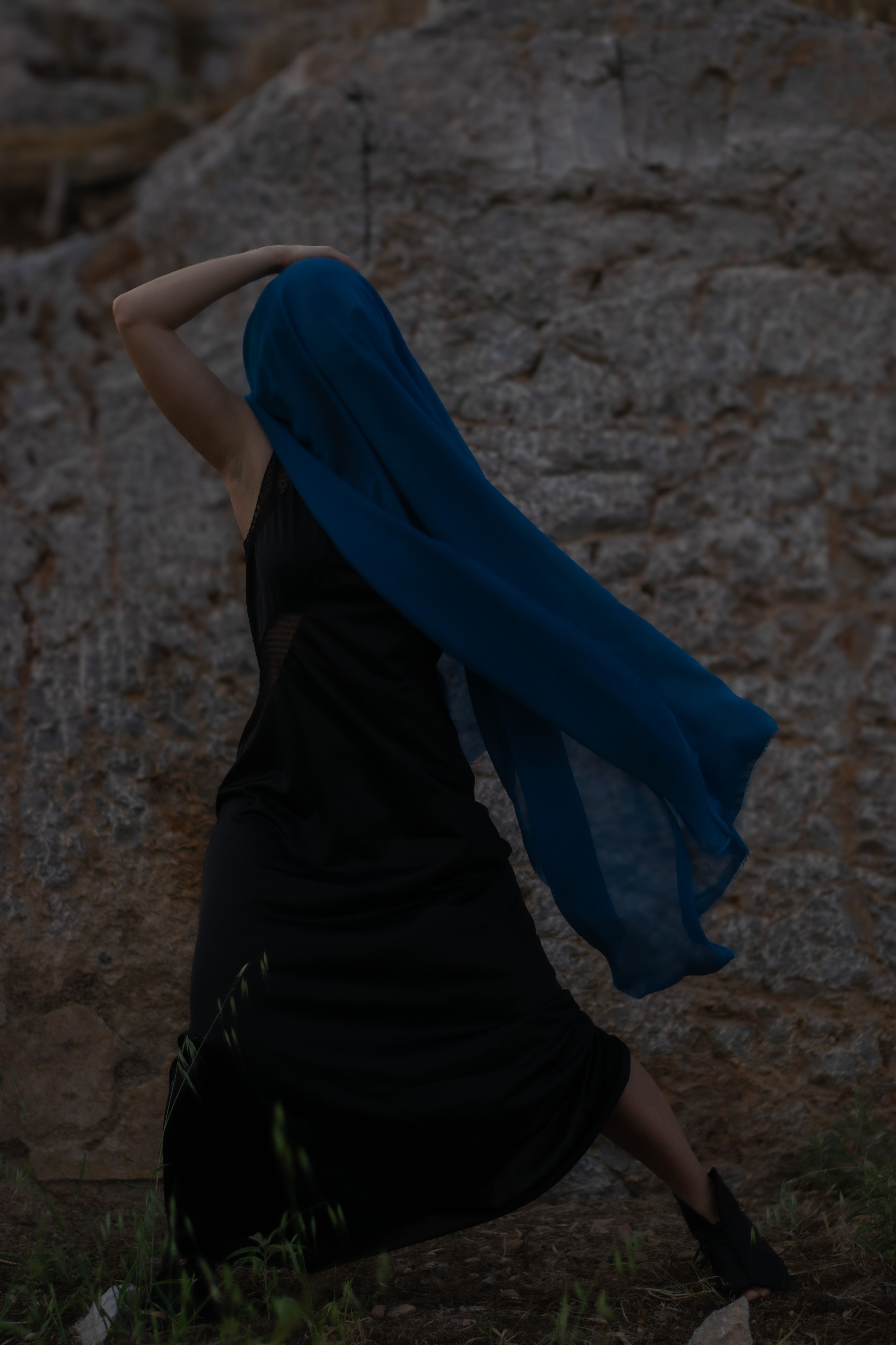Artistic Woman in Blue Veil in Front of Rock · Free Stock Photo
