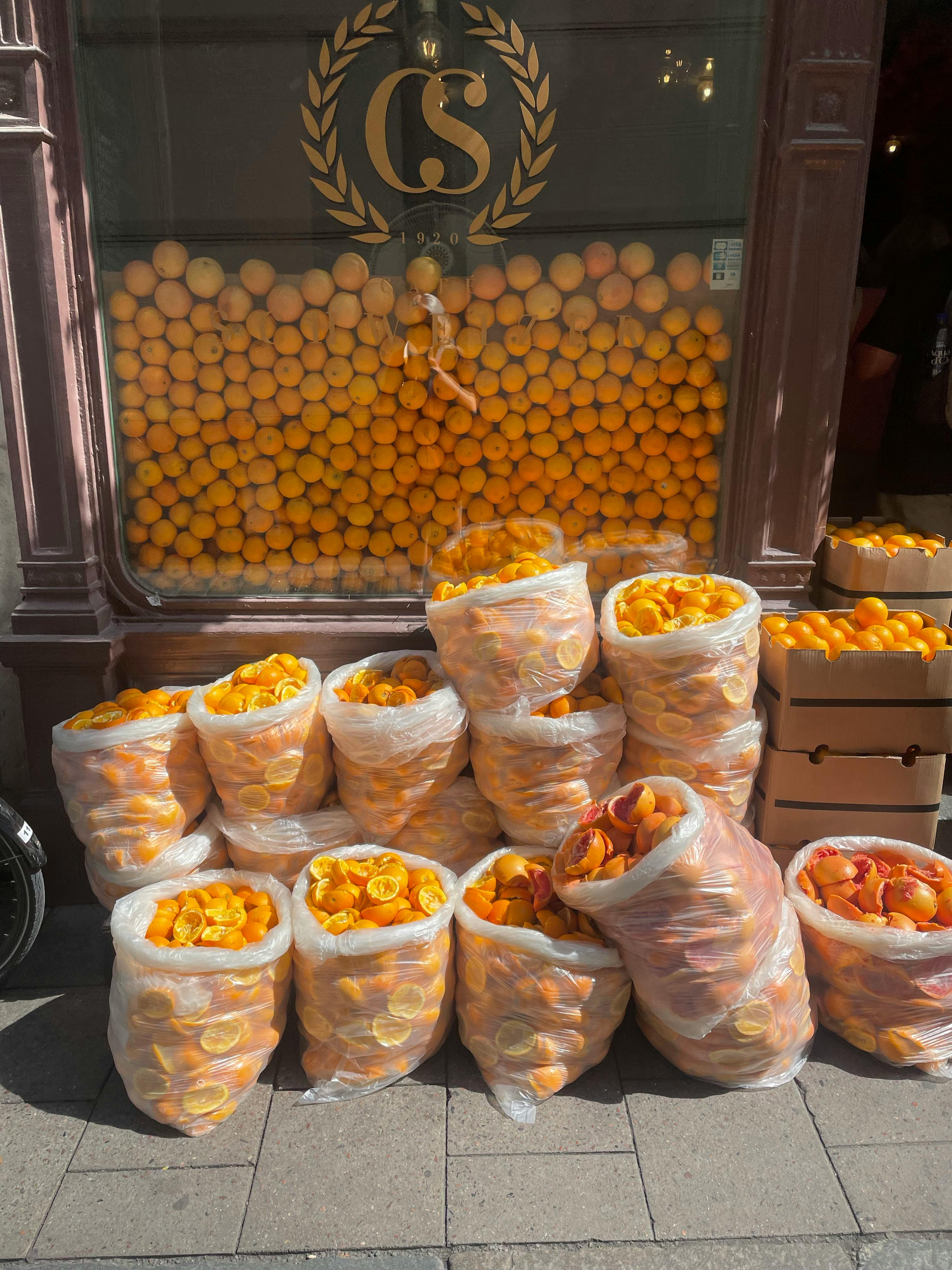 Bags of oranges and orange peels outside a shop in Stockholm, Sweden.