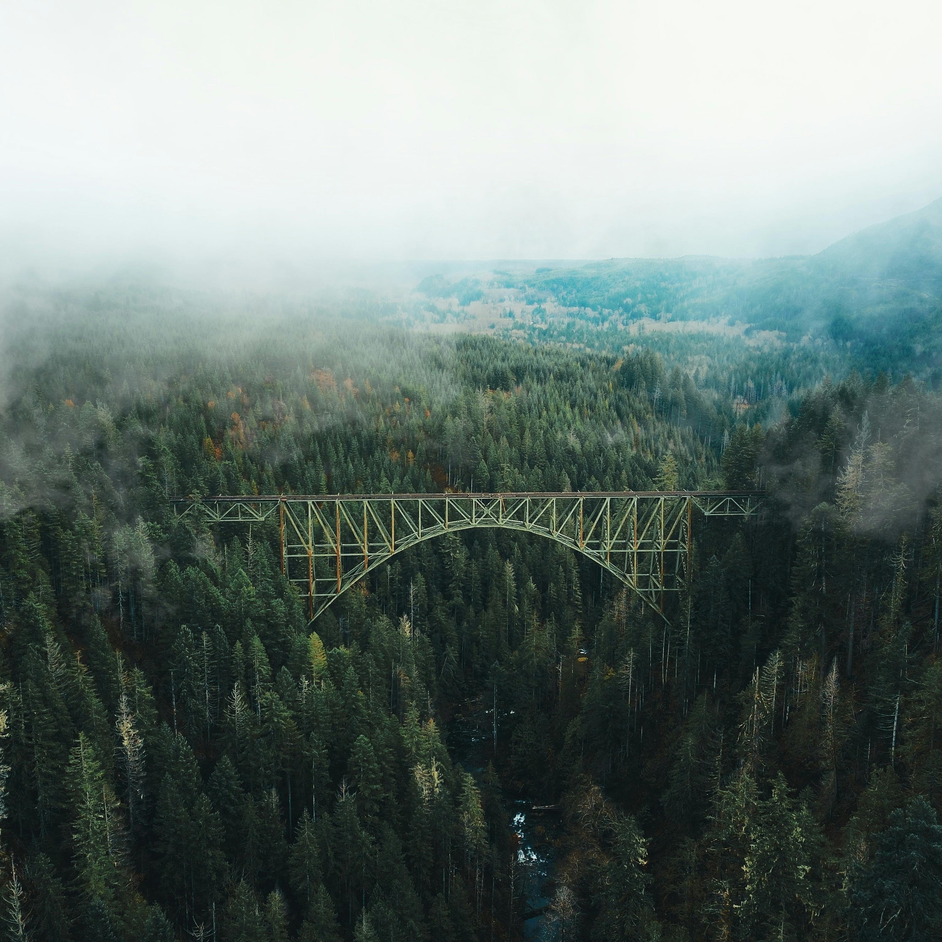 photo of bridge under white clouds