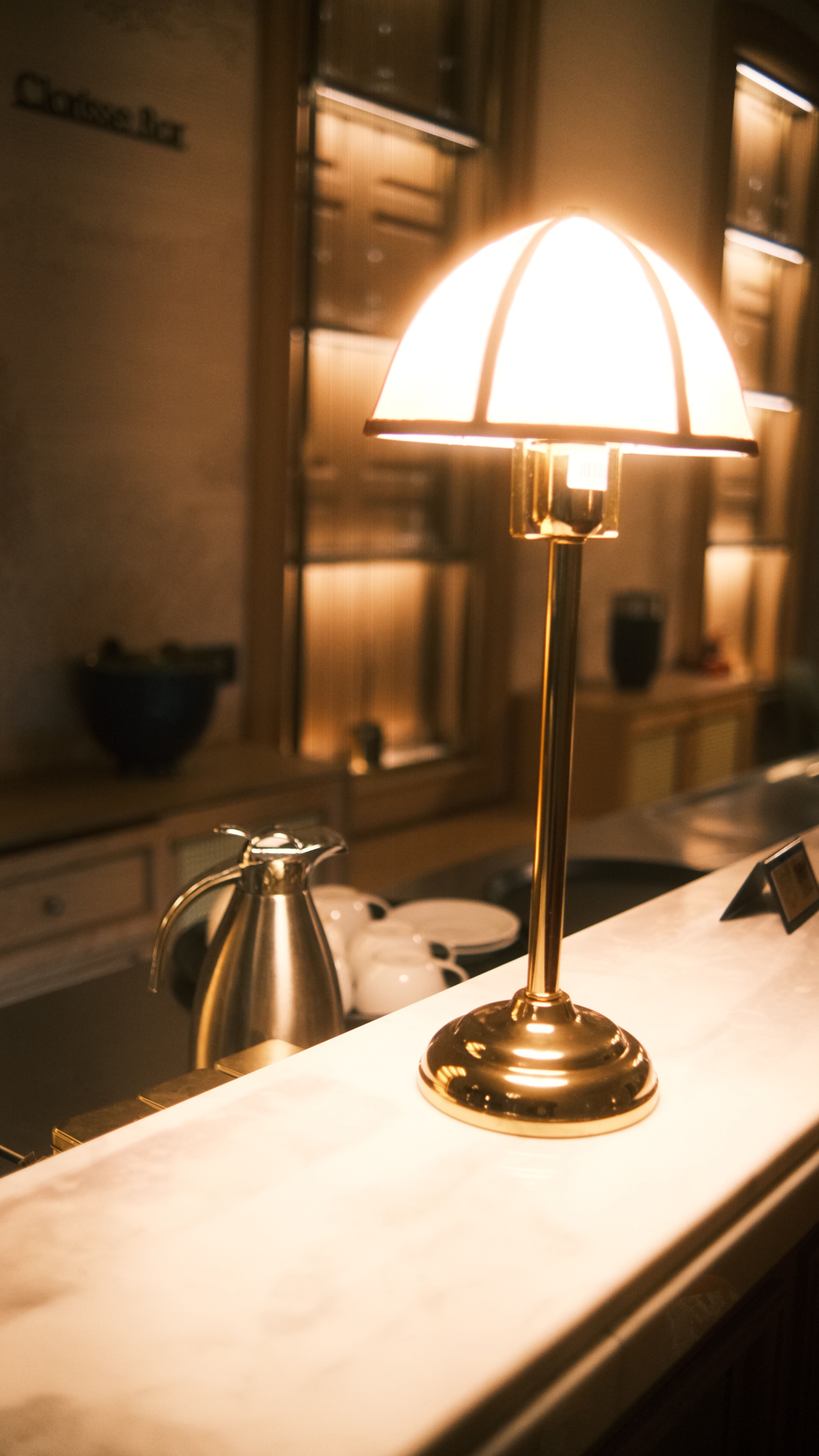 Brass arc floor lamp extending over a mid-century modern home coffee bar counter