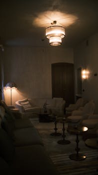Cozy living room featuring dim lighting and elegant furniture, creating a warm and serene atmosphere.