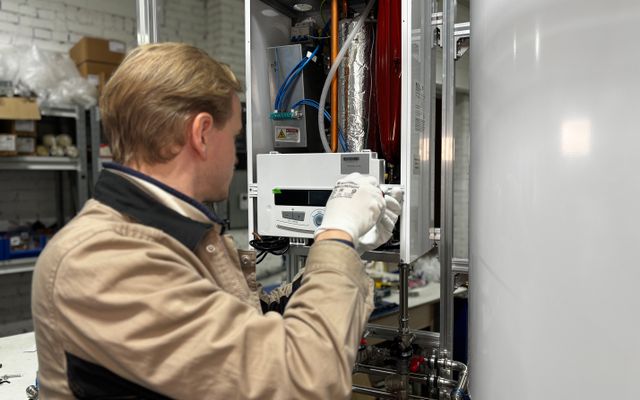 Technician servicing a heating appliance