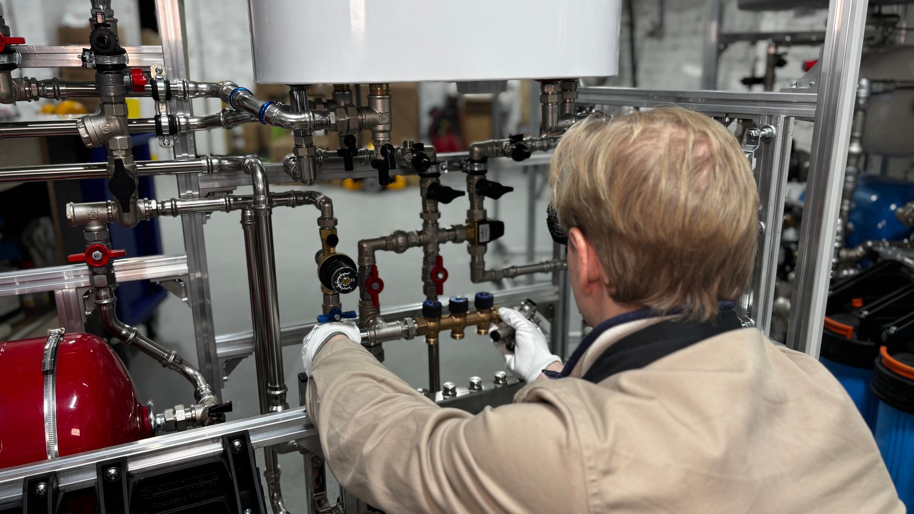 AL LIYARA engineer adjusting commercial industrial pipe systems