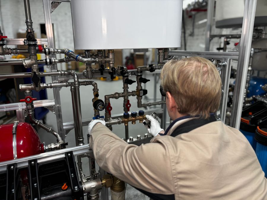 Engineer servicing central cooling pipework