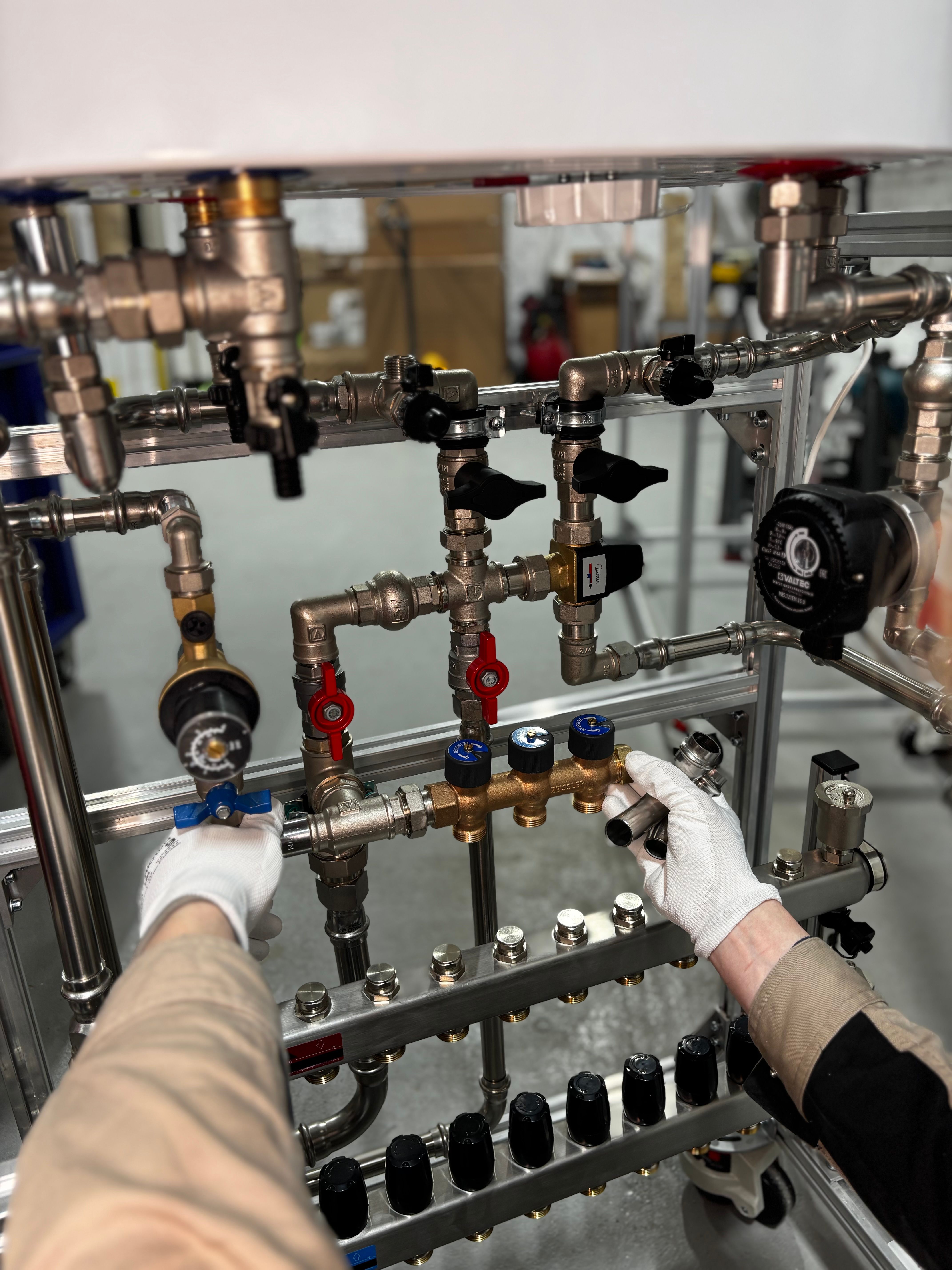 Technician adjusting industrial pipeline valves during a sewer inspection setup